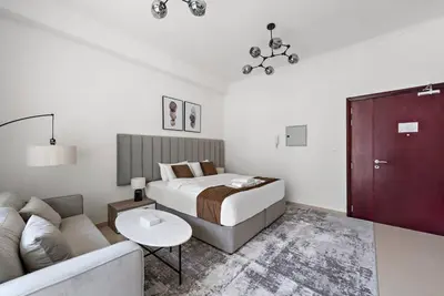 a bedroom with a bed and a couch at Studio -DEC Towers T2 - Near Marina Beach in Dubai