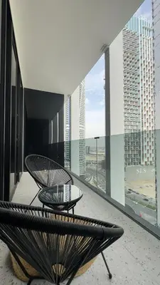 a balcony with a bench and a table on a building at Stylish apartment in the center!10 minutes to Dubai mall and World Trade Center in Dubai