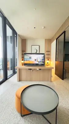 a living room with a table and a tv at Stylish apartment in the center!10 minutes to Dubai mall and World Trade Center in Dubai