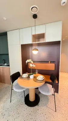 a dining room table with chairs and a table with flowers at Stylish apartment in the center!10 minutes to Dubai mall and World Trade Center in Dubai