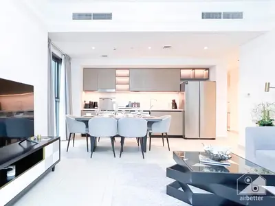 a kitchen and dining room with a table and chairs at Stunning Burj Crown 2Bedroom with Balcony & view in Dubai