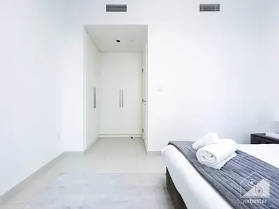 a bedroom with white walls and a bed with towels at Stunning Burj Crown 2Bedroom with Balcony & view in Dubai