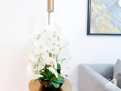 a vase of white flowers sitting on a table at Stunning Burj Crown 2Bedroom with Balcony & view in Dubai