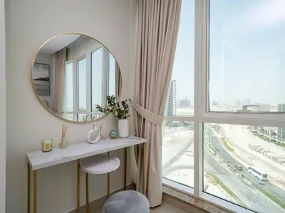 a dressing room with a mirror and a window at Sleek 2 Bed in Sports City in Dubai