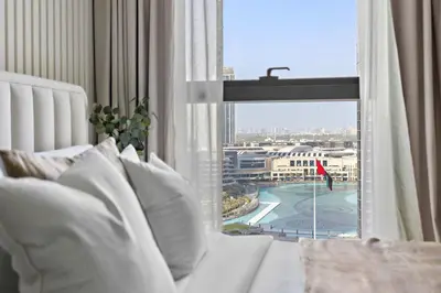 a bedroom with a white bed and a large window at Silkhaus Heart of Downtown 3 BDR with Maid Room in Dubai