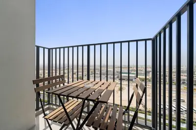 a balcony with two benches and a view of the city at Silkhaus Next Golf Club Golfville in Dubai Hills in Dubai