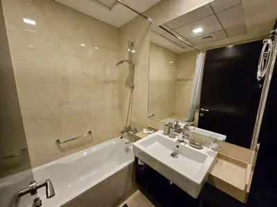 a bathroom with a sink and a bath tub and a sink at A stylish studio apartment so close to beach in Dubai
