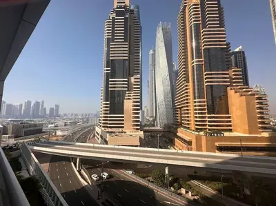a view of a city with tall buildings and a highway at A stylish studio apartment so close to beach in Dubai