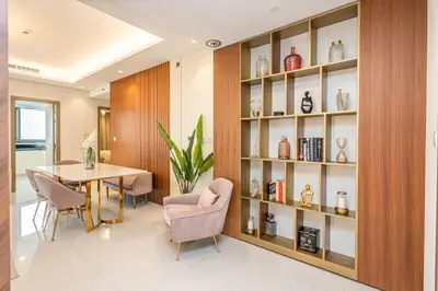 a dining room with a table and a shelf of vases at Escape24 Spacious 2BR Infinity Pool with Burj Views in Dubai