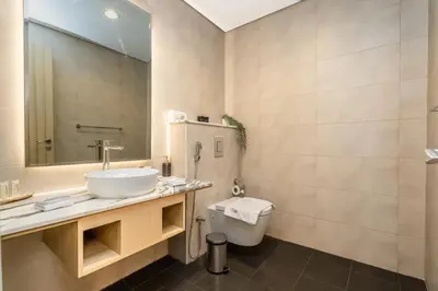 a bathroom with a sink and a toilet at Escape24 Spacious 2BR Infinity Pool with Burj Views in Dubai
