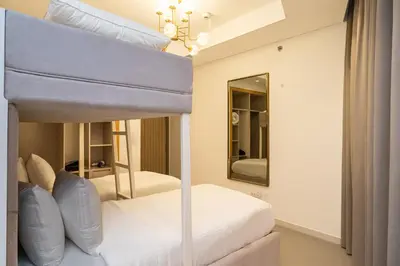 a bedroom with two bunk beds and a mirror at Escape24 Spacious 2BR Infinity Pool with Burj Views in Dubai