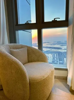 a chair in a room with a large window at Breathtaking 2BR with Full SeaView in Dubai