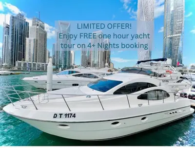 a white boat in the water with other boats at Breathtaking 2BR with Full SeaView in Dubai