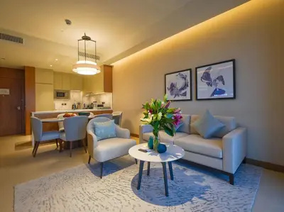 a living room with a couch and chairs and a table at Venetian - The Address Residences Dubai Opera Full Burj & Fountain Views in Dubai
