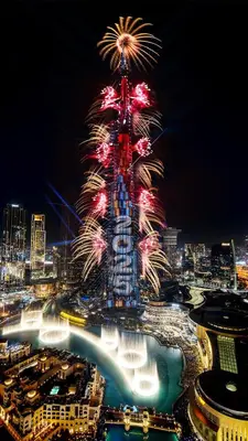 a tall tower with fireworks in a city at night at Luxury Suite at Address Residences Dubai Opera , High-Floor Ocean Views, Burj Khalifa Pool Access, Steps from Dubai Mall in Dubai