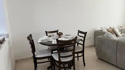 a dining room with a table and chairs and a couch at Venetian - Stay in Business Bay near Burj Khalifa views in Dubai