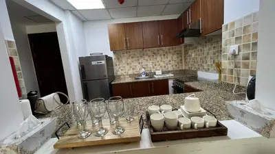 a kitchen with a counter with wine glasses on it at Venetian - Stay in Business Bay near Burj Khalifa views in Dubai