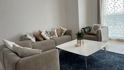 a living room with two couches and a table at Venetian - Stay in Business Bay near Burj Khalifa views in Dubai