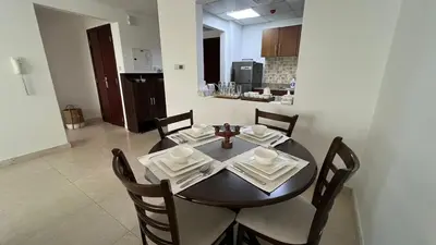 a dining room table and chairs in a kitchen at Venetian - Stay in Business Bay near Burj Khalifa views in Dubai