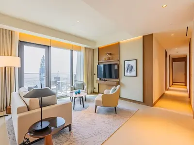 a living room with a couch and a tv at Luxury 3BR Apartment at Address Opera in Dubai