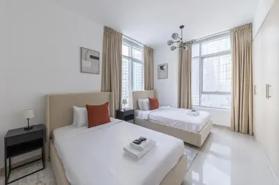 a hotel room with two beds and a window at Stylish 2 bd Apt in Business Bay, Prime Location in Dubai