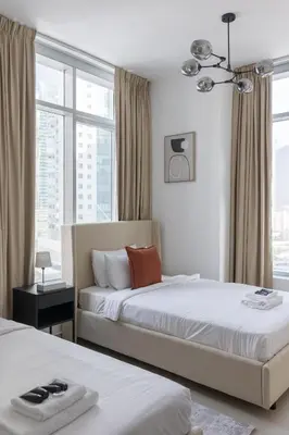 a hotel room with two beds and a window at Stylish 2 bd Apt in Business Bay, Prime Location in Dubai