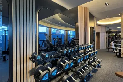a row of exercise equipment in a hotel gym at DIFC Luxury 1-Bed Apt with Stunning City Views in Dubai