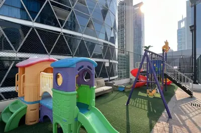 a playground with a slide and a swing at DIFC Luxury 1-Bed Apt with Stunning City Views in Dubai