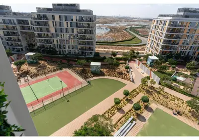 an aerial view of a tennis court and buildings at Bright and Modern 1BR Midtown Near Expo Site by Vibel in Dubai
