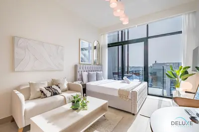 a living room with a bed and a couch at Spacious Studio with Community and Partial Burj Khalifa Views by Deluxe Holiday Homes in Dubai