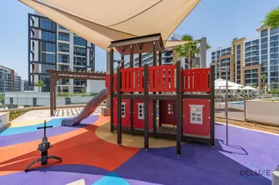a playground in a city with a slide at Spacious Studio with Community and Partial Burj Khalifa Views by Deluxe Holiday Homes in Dubai