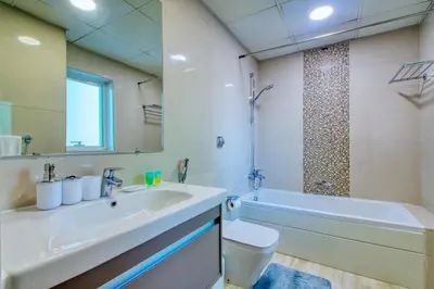 a bathroom with a sink and a tub and a toilet at ShoresInn - Dreamy Marina Views in Dubai in Dubai