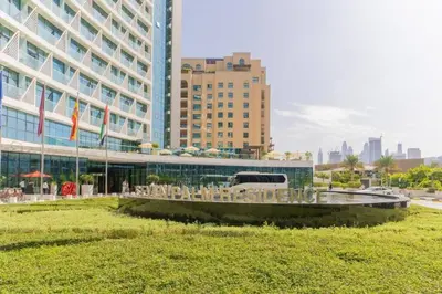 a building with a bunch of chairs in front of it at Palm Jumeirah Seven Palm 1 Bedroom with infinity pool and Palm jumeirah beach in Dubai