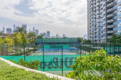 a tennis court on the roof of a building at Palm Jumeirah Seven Palm 1 Bedroom with infinity pool and Palm jumeirah beach in Dubai
