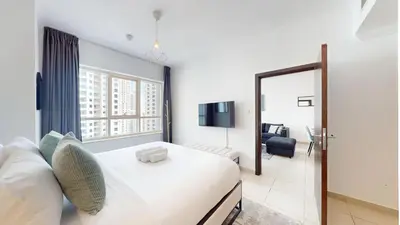a hotel room with a bed and a mirror at Marina Quays - Calm One Bedroom in Dubai