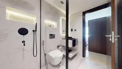 a bathroom with a toilet and a glass shower at Marina Quays - Calm One Bedroom in Dubai