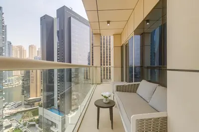 a balcony with a couch and a view of a city at Sleek and Modern 2BR in West Avenue, Dubai Marina- Allsopp&Allsopp in Dubai