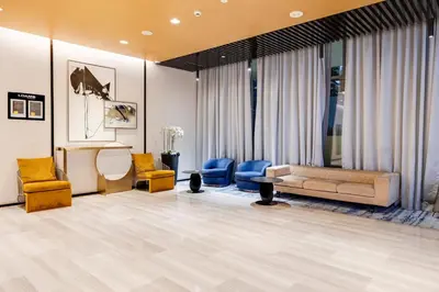 a living room with a couch and chairs at Chic 1BR Getaway- 4min Walk to Business Bay Metro & 10min to Burj Khalifa in Dubai
