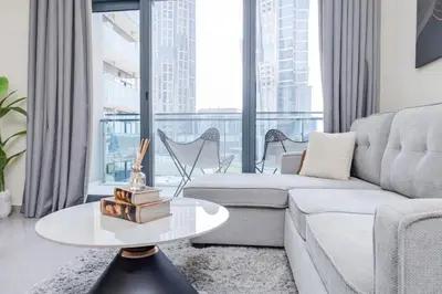 a living room with a couch and a table at Chic 1BR Getaway- 4min Walk to Business Bay Metro & 10min to Burj Khalifa in Dubai