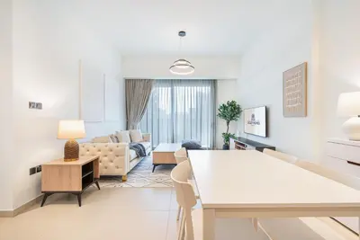 a living room with a couch and a table at Premium Home Minutes away from Burj Khalifa in Dubai