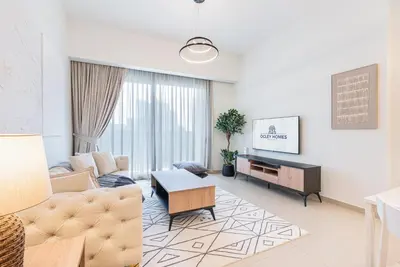 a living room with a couch and a table at Premium Home Minutes away from Burj Khalifa in Dubai