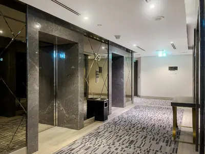 a hallway with glass doors and a tile floor at Stylish 1BR Apartment at DAMAC Merano Tower with Great View in Dubai