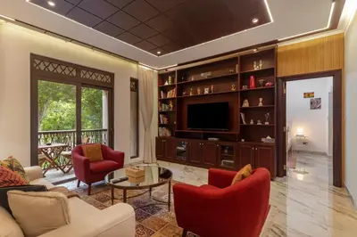 a living room with red chairs and a television at Yansoon 7,Oldtown-Downtown - 2BR & Maids Room - Allsopp&Allsopp in Dubai