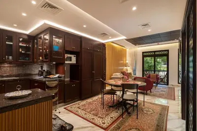 a kitchen and living room with a table and chairs at Yansoon 7,Oldtown-Downtown - 2BR & Maids Room - Allsopp&Allsopp in Dubai