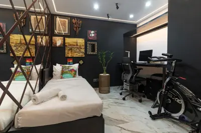 a bedroom with a bed and a desk and a bike at Yansoon 7,Oldtown-Downtown - 2BR & Maids Room - Allsopp&Allsopp in Dubai