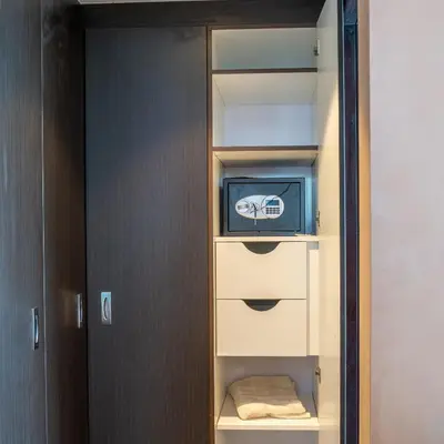 a closet with a tv and a cabinet with a towel at Paradise of the Mind by Lagom in Dubai