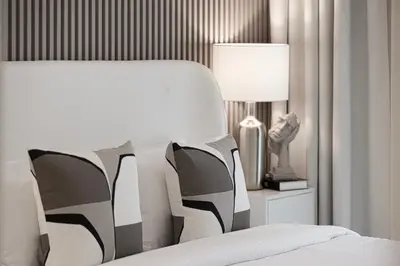 a bedroom with a bed with a lamp and pillows at Burj Crown - Urban Chic Opera Boulevard View, Walk to Dubai Mall in Dubai