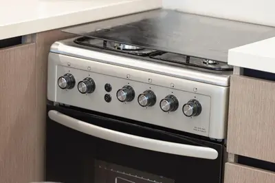 a stove top oven sitting in a kitchen at Burj Crown - Urban Chic Opera Boulevard View, Walk to Dubai Mall in Dubai