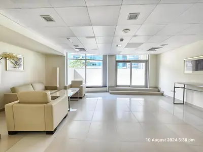 an empty waiting room with chairs and a table at Vacay Lettings - Lofts Apartments in Dubai