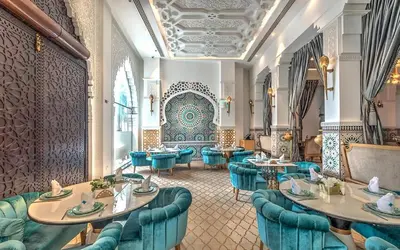 a restaurant with blue chairs and tables at Vacay Lettings - Lofts Apartments in Dubai